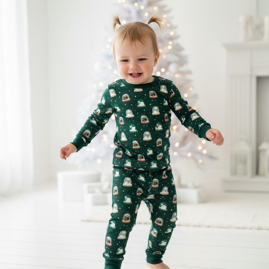 Child wearing pajamas with tiny snow globes